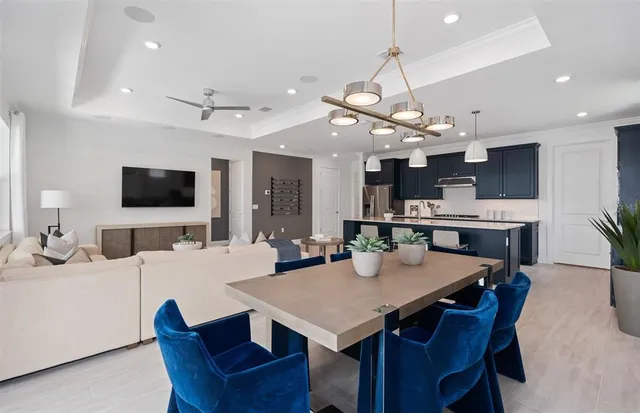 a living room with furniture kitchen view and a flat screen tv
