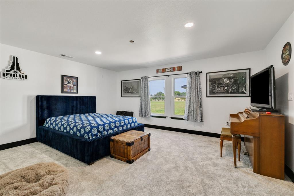 12240 Wellington Road Ponder, TX 76259 - Photo 20 of 40 Carpeted room featuring white walls with black trim, recessed lighting, and two windows offering exterior views