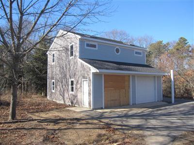 141 Lincoln Road Hyannis, MA 02601 - Photo 19 of 23 a front view of a house with a yard and garage