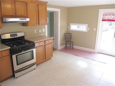 141 Lincoln Road Hyannis, MA 02601 - Photo 9 of 23 a kitchen with granite countertop a stove a sink and a microwave