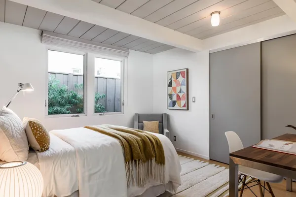 a bedroom with a bed and a window