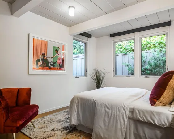 a bedroom with a large bed and a couch