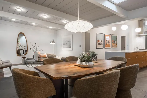 a dining room with furniture and a chandelier