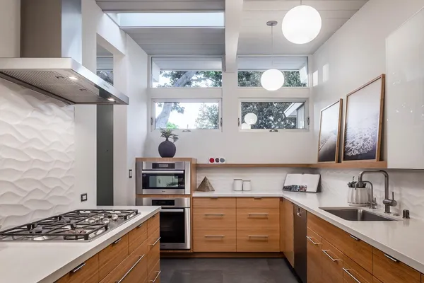 a kitchen with stainless steel appliances granite countertop a stove and a sink