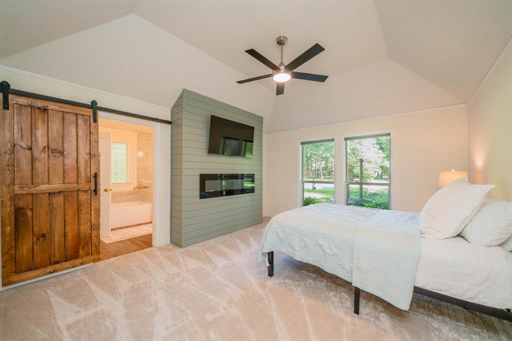 234 Spring Lake Knoll Trail Holly Lake Ranch, TX 75765 - Photo 11 of 20 a bedroom with a large bed and a window