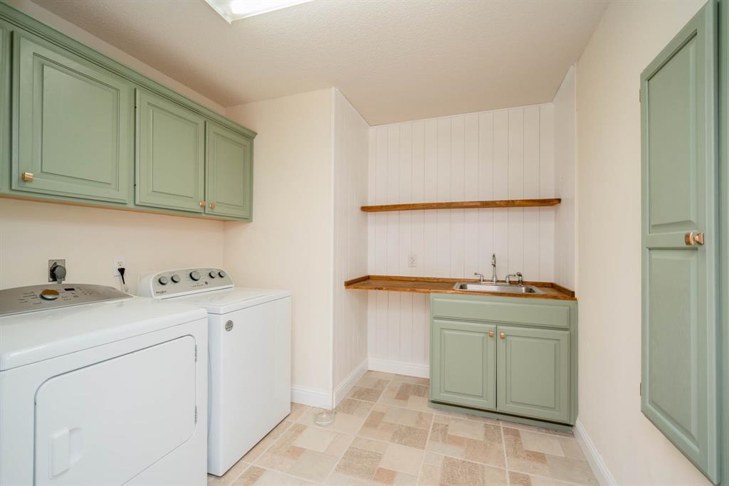 234 Spring Lake Knoll Trail Holly Lake Ranch, TX 75765 - Photo 18 of 20 a utility room with stainless steel appliances granite countertop a sink and dishwasher