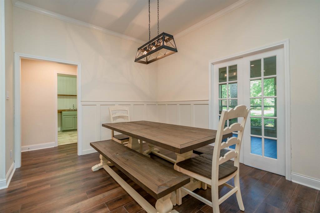 234 Spring Lake Knoll Trail Holly Lake Ranch, TX 75765 - Photo 9 of 20 a living room with a table chairs and wooden floor