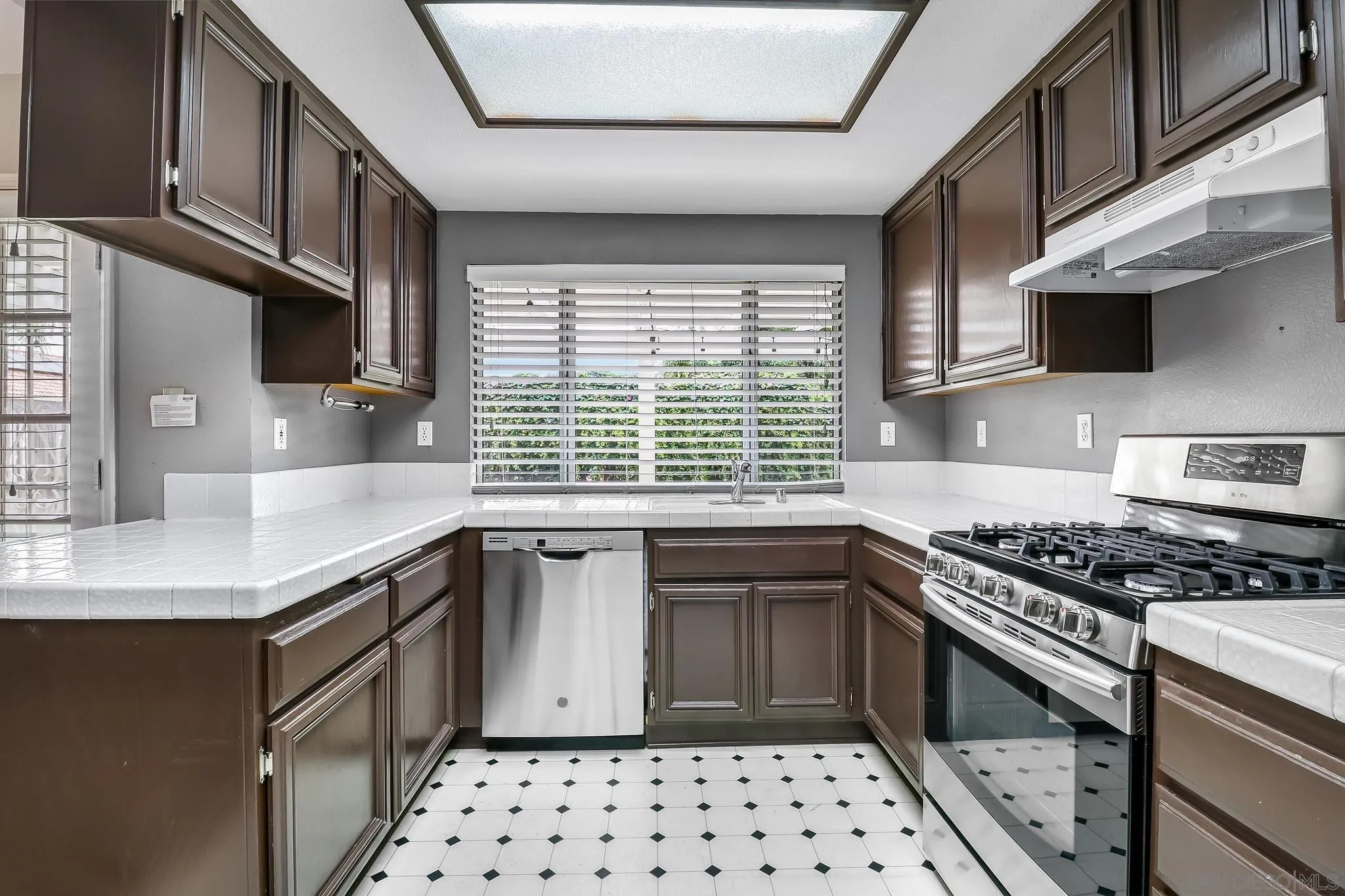 39884 North General Kearny Road Temecula, CA 92591 - Photo 11 of 58 a kitchen with stainless steel appliances a sink a stove a microwave cabinets and a window