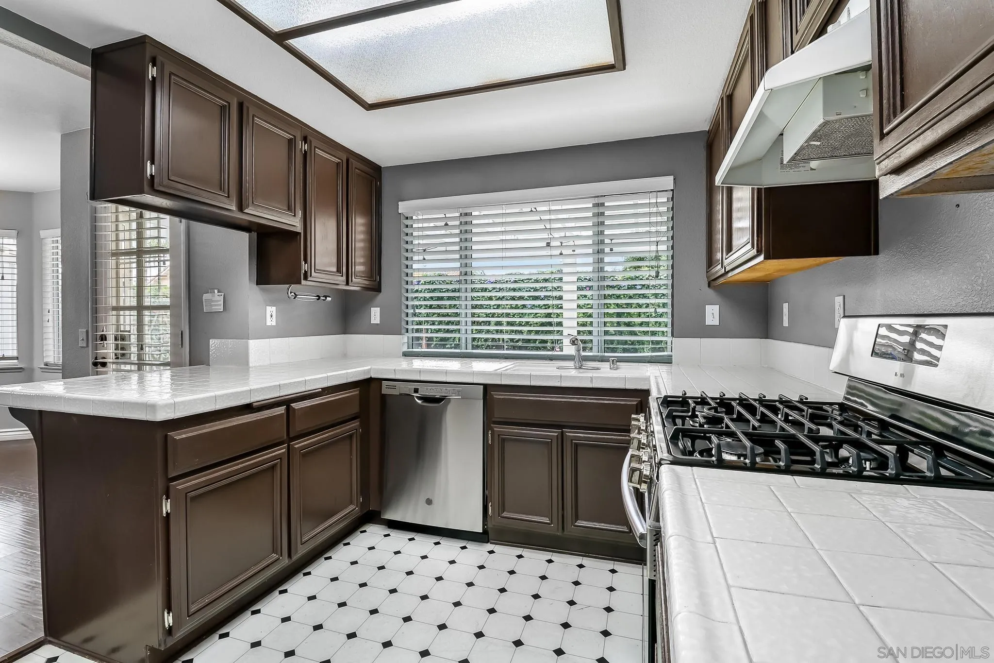 39884 North General Kearny Road Temecula, CA 92591 - Photo 12 of 58 a kitchen with a sink a stove cabinets and a window