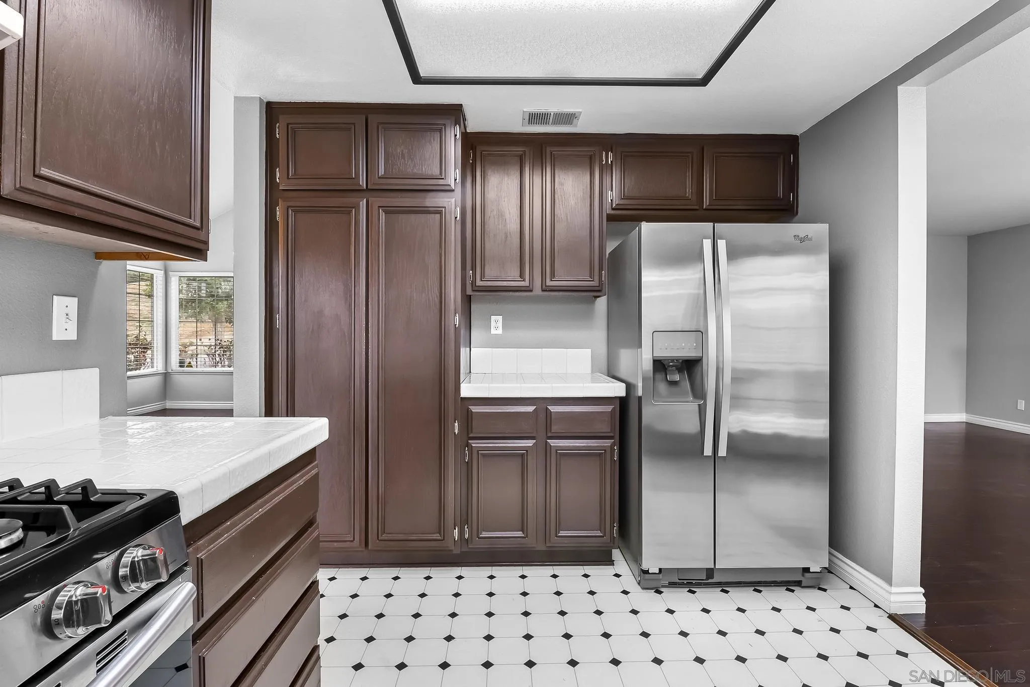 39884 North General Kearny Road Temecula, CA 92591 - Photo 14 of 58 a kitchen with granite countertop a refrigerator and a stove top oven