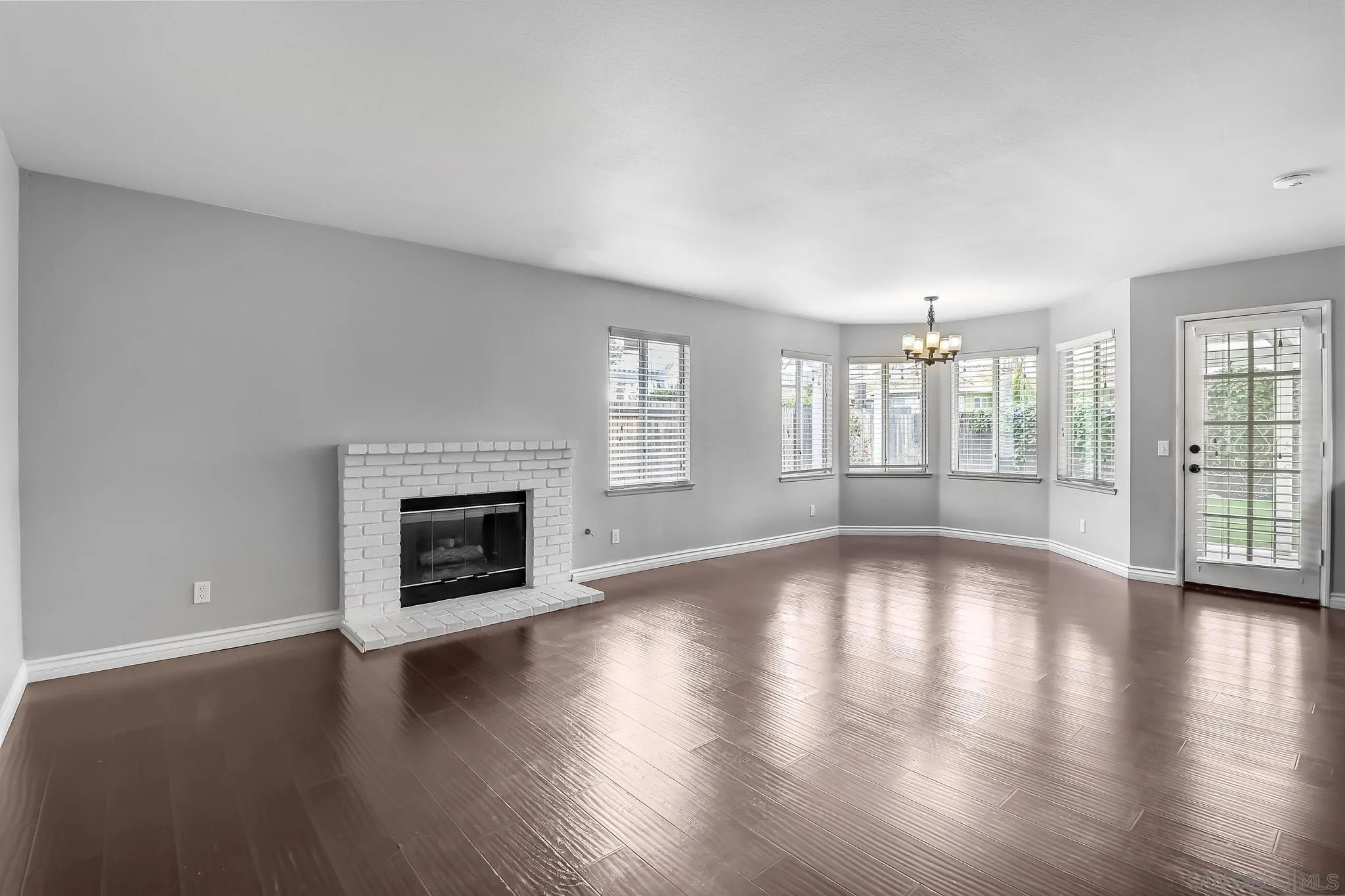 39884 North General Kearny Road Temecula, CA 92591 - Photo 17 of 58 an empty room with wooden floor and fireplace