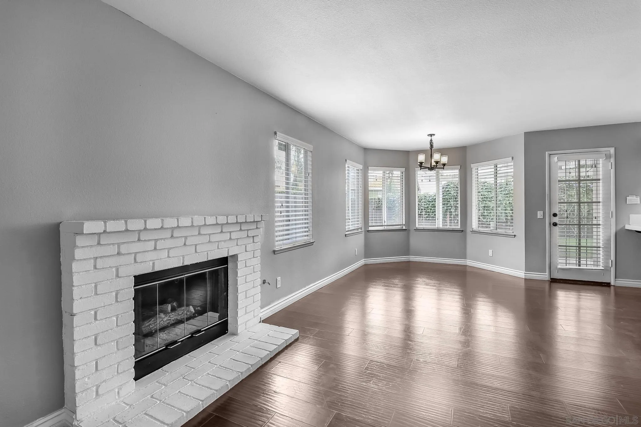 39884 North General Kearny Road Temecula, CA 92591 - Photo 19 of 58 an empty room with large windows and fireplace