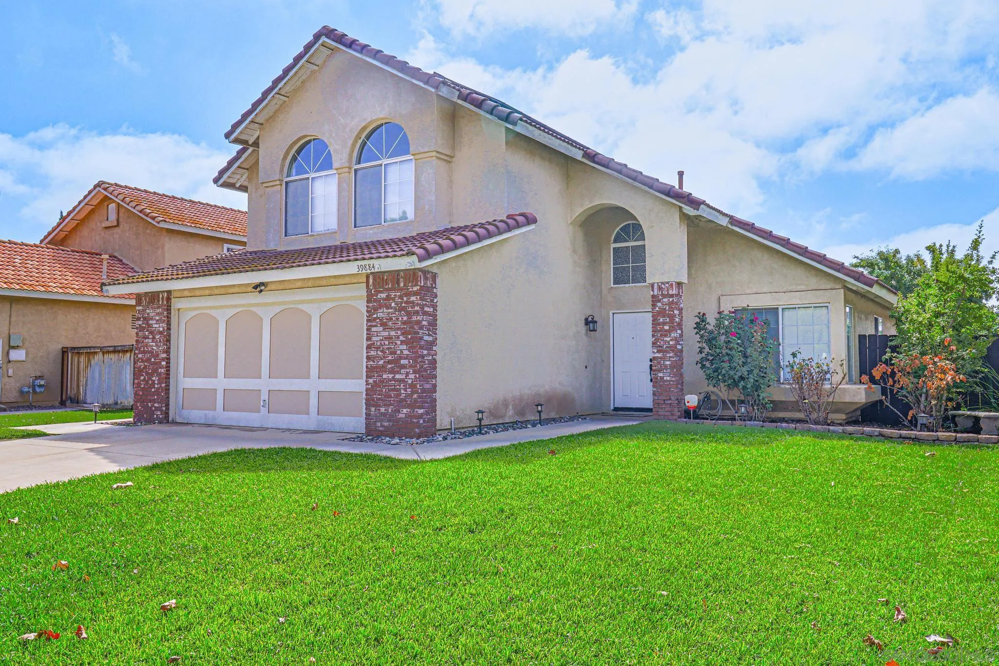39884 North General Kearny Road Temecula, CA 92591 - Photo 2 of 58 a front view of a house with a garden and yard