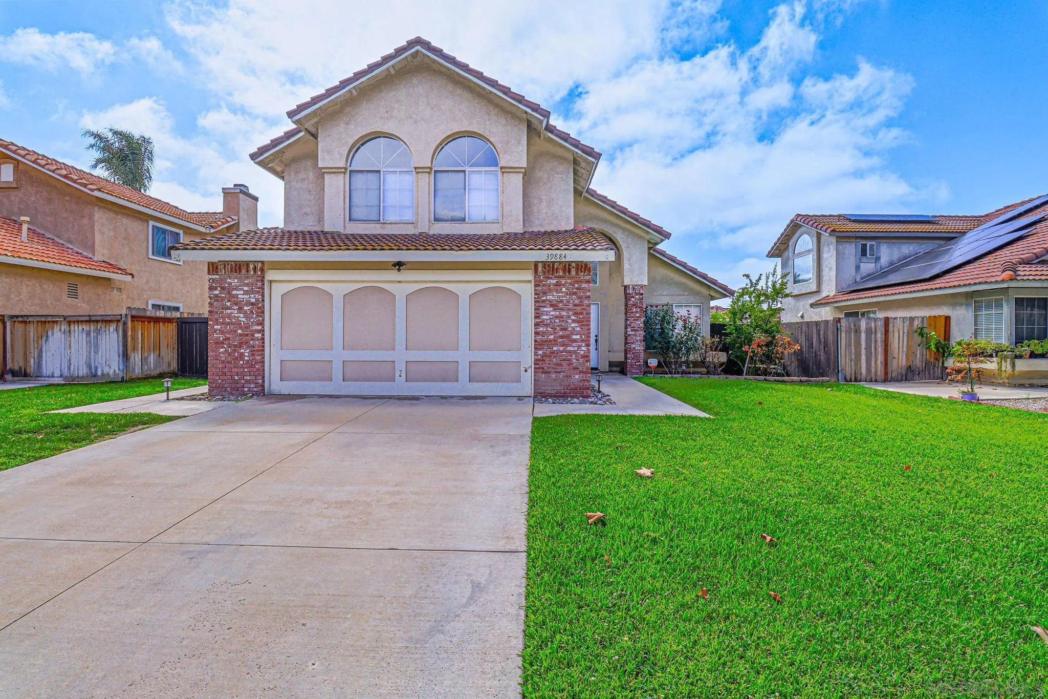 39884 North General Kearny Road Temecula, CA 92591 - Photo 3 of 58 a front view of a house with a yard and garage