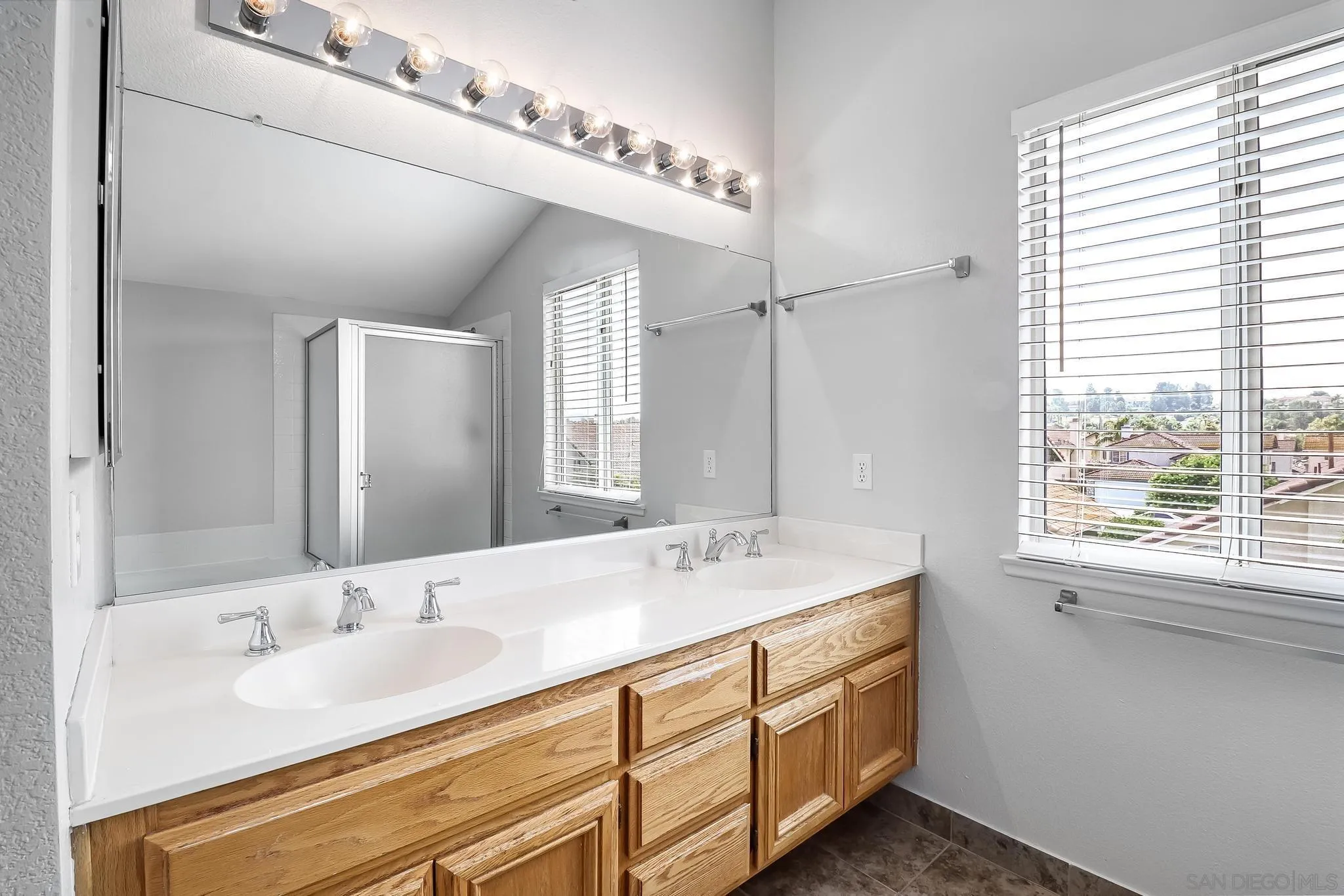 39884 North General Kearny Road Temecula, CA 92591 - Photo 38 of 58 a bathroom with a double vanity sink and a mirror