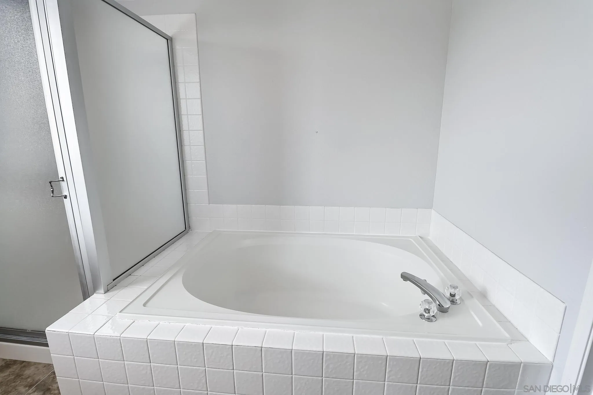 39884 North General Kearny Road Temecula, CA 92591 - Photo 40 of 58 a bath tub sitting in a bathroom next to a sink