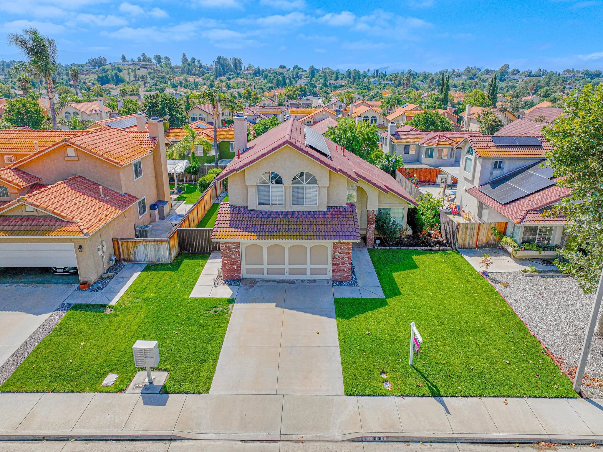 39884 North General Kearny Road Temecula, CA 92591 - Photo 53 of 58 a front view of a house with a yard and trees