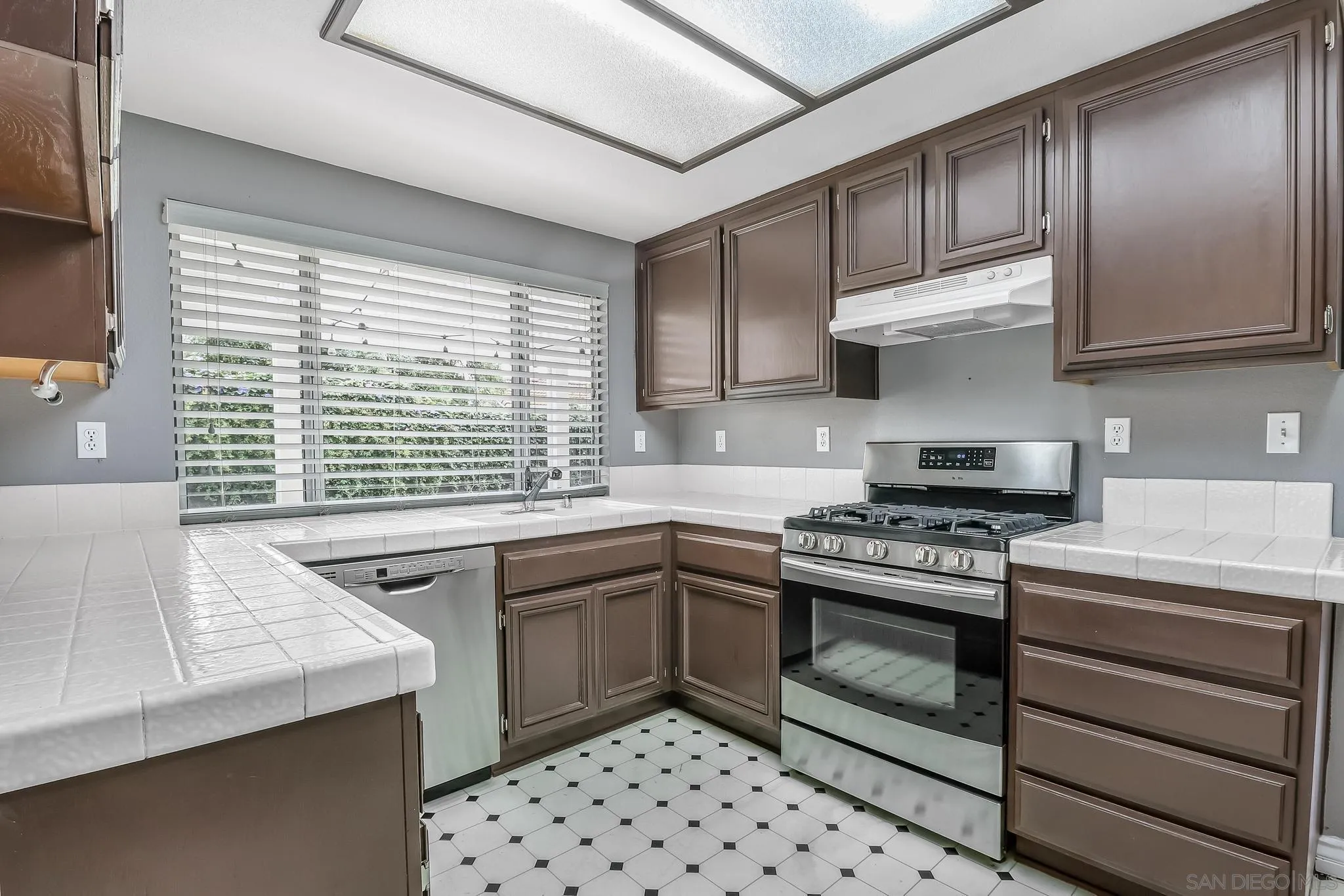 39884 North General Kearny Road Temecula, CA 92591 - Photo 10 of 58 a kitchen with stainless steel appliances a stove a sink and a microwave