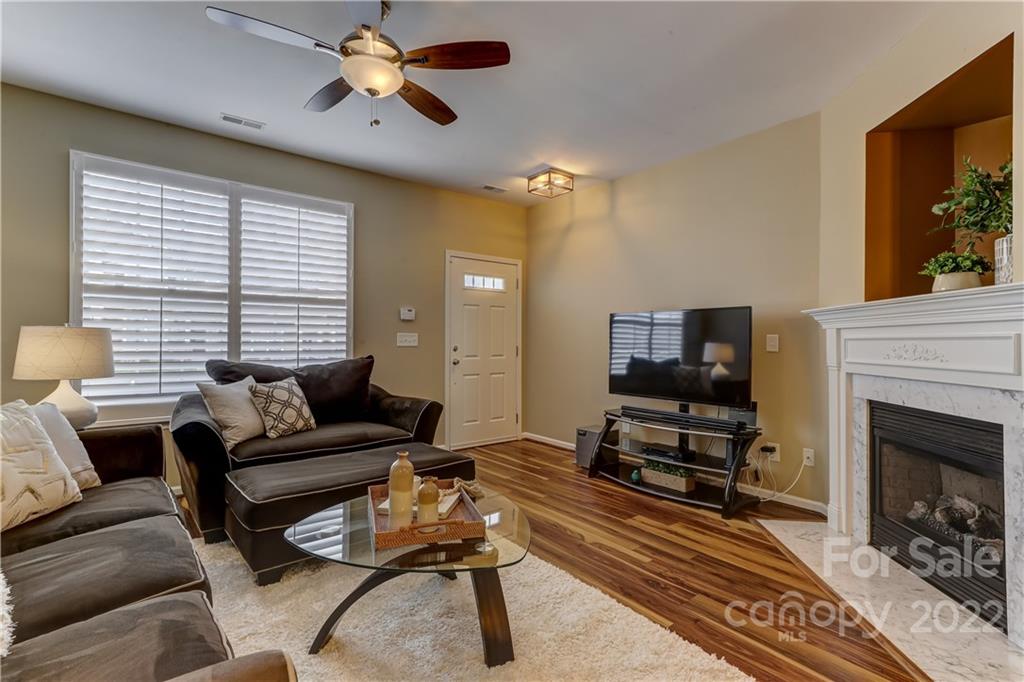 839 Gentlewinds Court Fort Mill, SC 29708 - Photo 8 of 36 a living room with furniture a flat screen tv and a fireplace