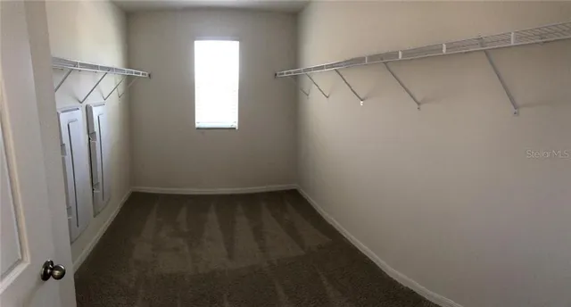 a bathroom with a granite countertop sink and mirror