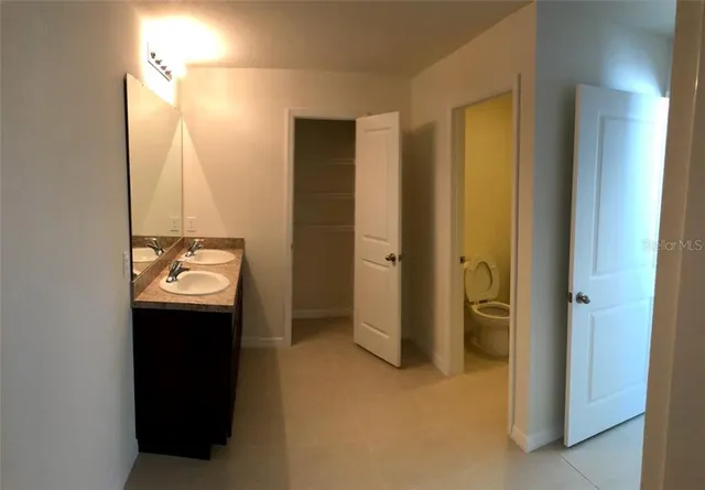 a bathroom with a double vanity sink and a bathtub