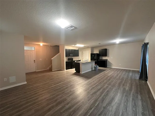 a view of kitchen and refrigerator