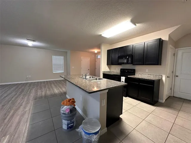 a kitchen with a sink cabinets and appliances