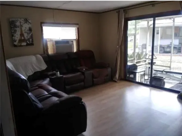 a living room with furniture and a floor to ceiling window