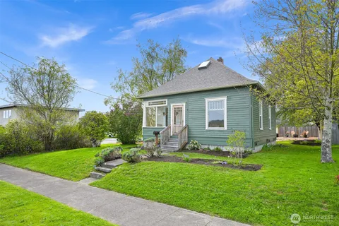a front view of house with yard and green space