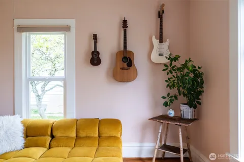 a view of a hallway with wooden floor and a bedroom