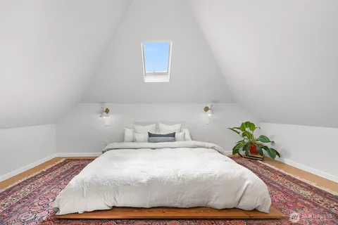 a bedroom with a bed and a potted plant