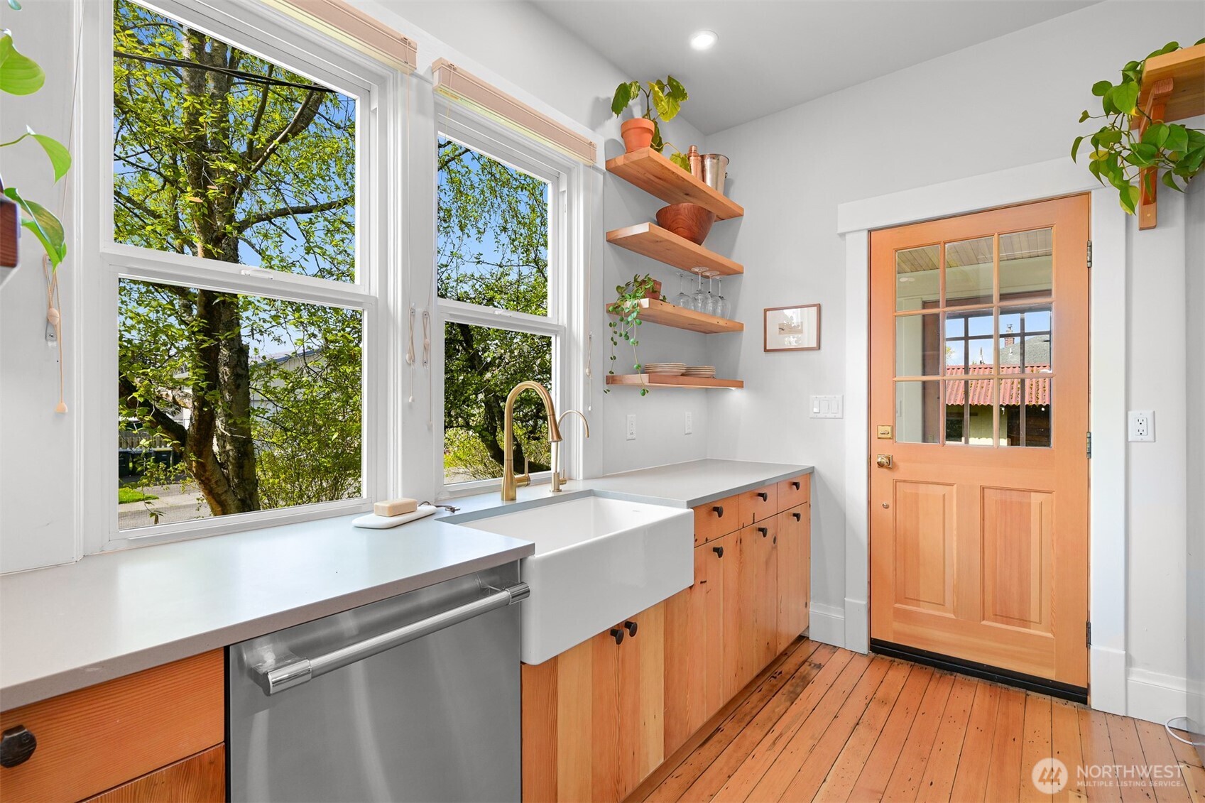 2301 I Street Bellingham, WA 98225 - Photo 8 of 28 a kitchen with granite countertop a stove a sink and wooden floors