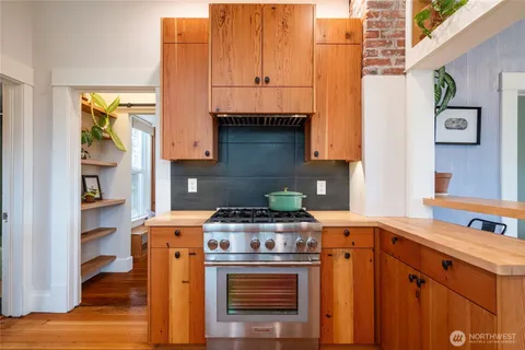 a kitchen with stainless steel appliances granite countertop a stove and a microwave