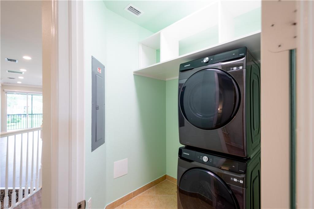 6533 Monterey Point, Unit 204 Naples, FL 34105 - Photo 17 of 41 a utility room with dryer and washer