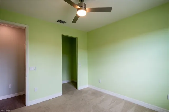 a bathroom with a granite countertop sink toilet mirror and shower