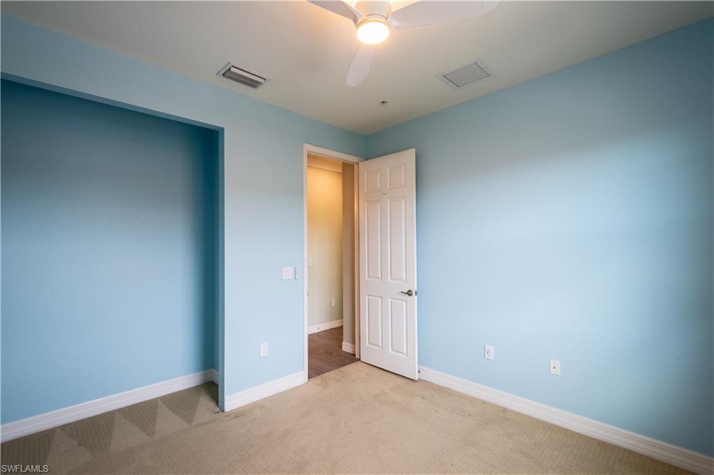 6533 Monterey Point, Unit 204 Naples, FL 34105 - Photo 24 of 41 an empty room with a ceiling fan and window