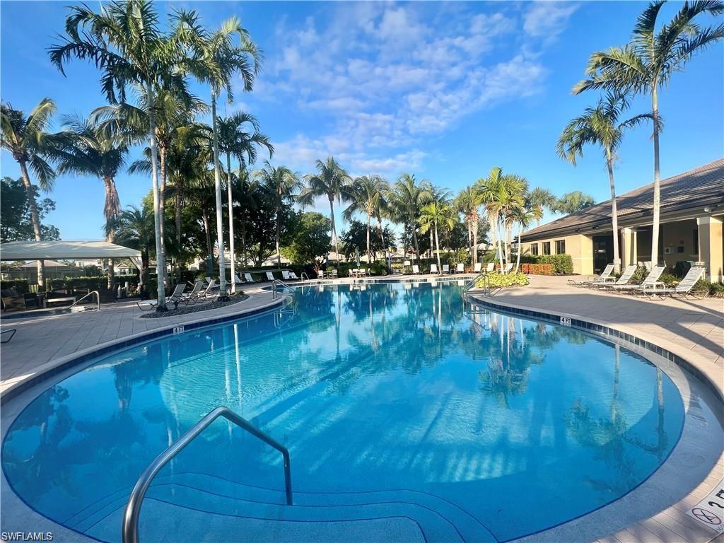 6533 Monterey Point, Unit 204 Naples, FL 34105 - Photo 33 of 41 a swimming pool with outdoor seating and yard