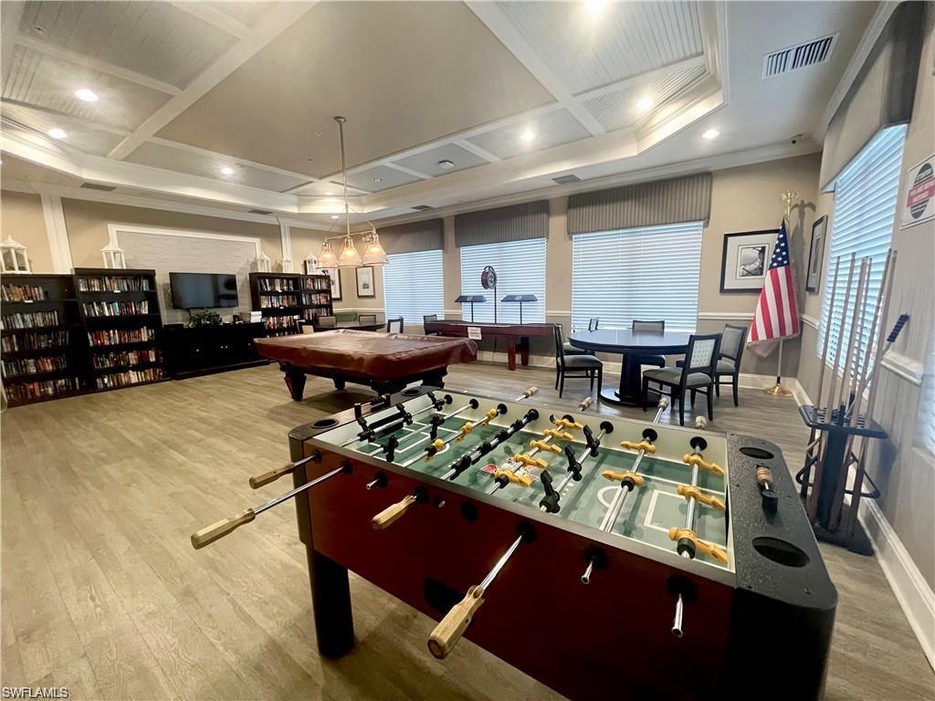 6533 Monterey Point, Unit 204 Naples, FL 34105 - Photo 38 of 41 a living room with lots of furniture and a wooden floor