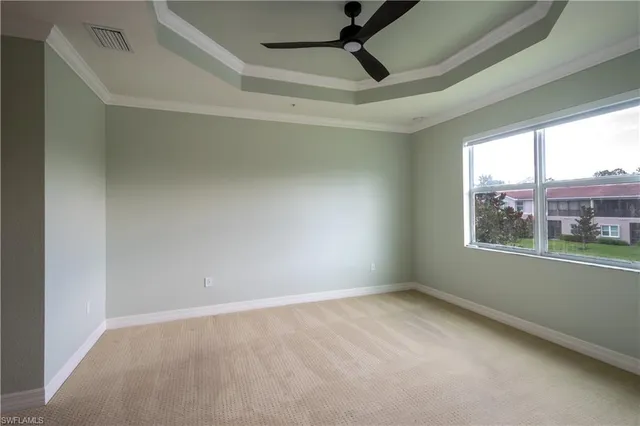 a view of a room with a ceiling fan