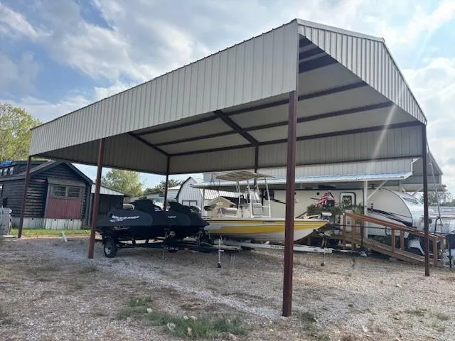 a view of patio with table and chairs under an umbrella