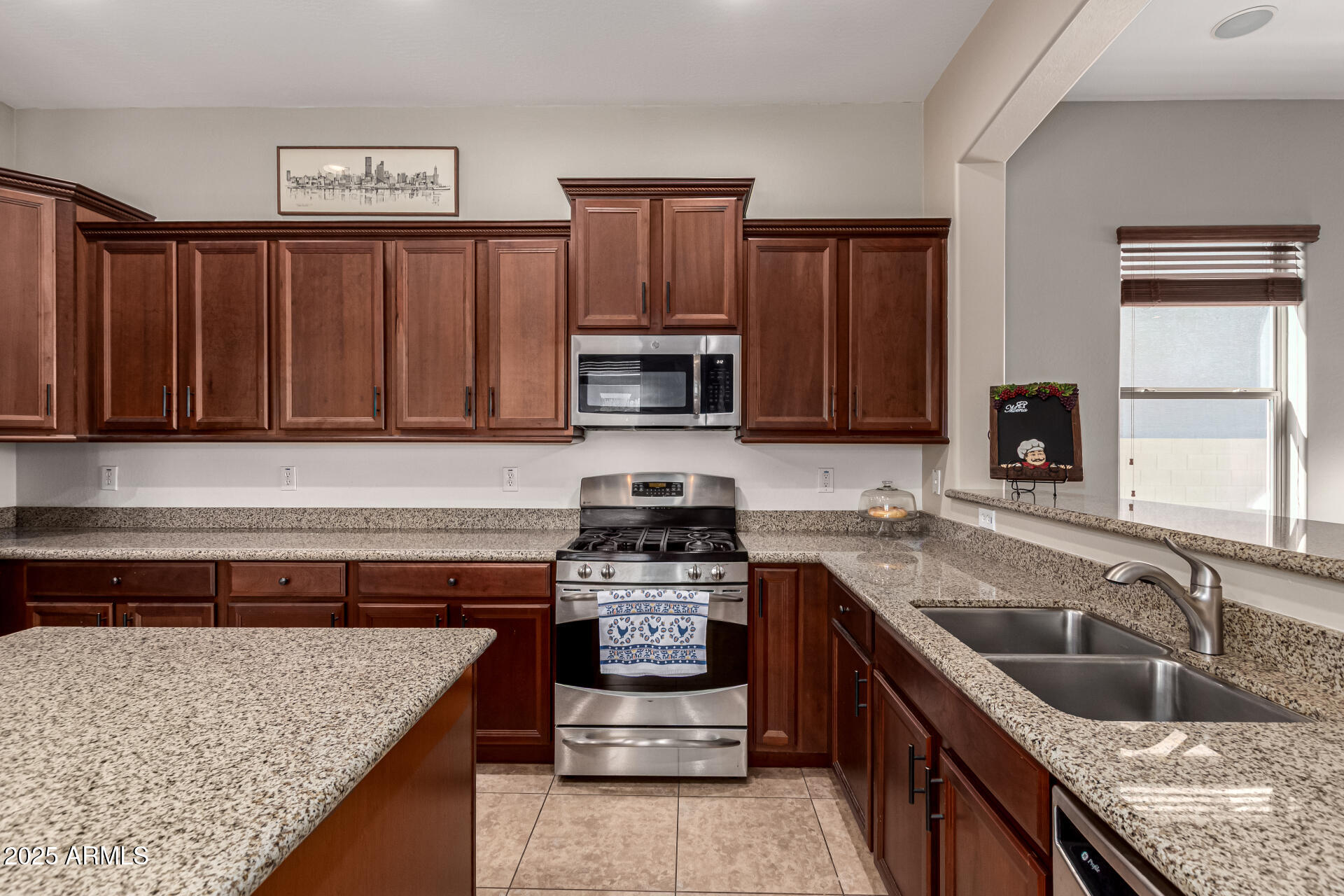 3914 East Constance Way Phoenix, AZ 85042 - Photo 33 of 81 a kitchen with stainless steel appliances granite countertop a sink stove and refrigerator