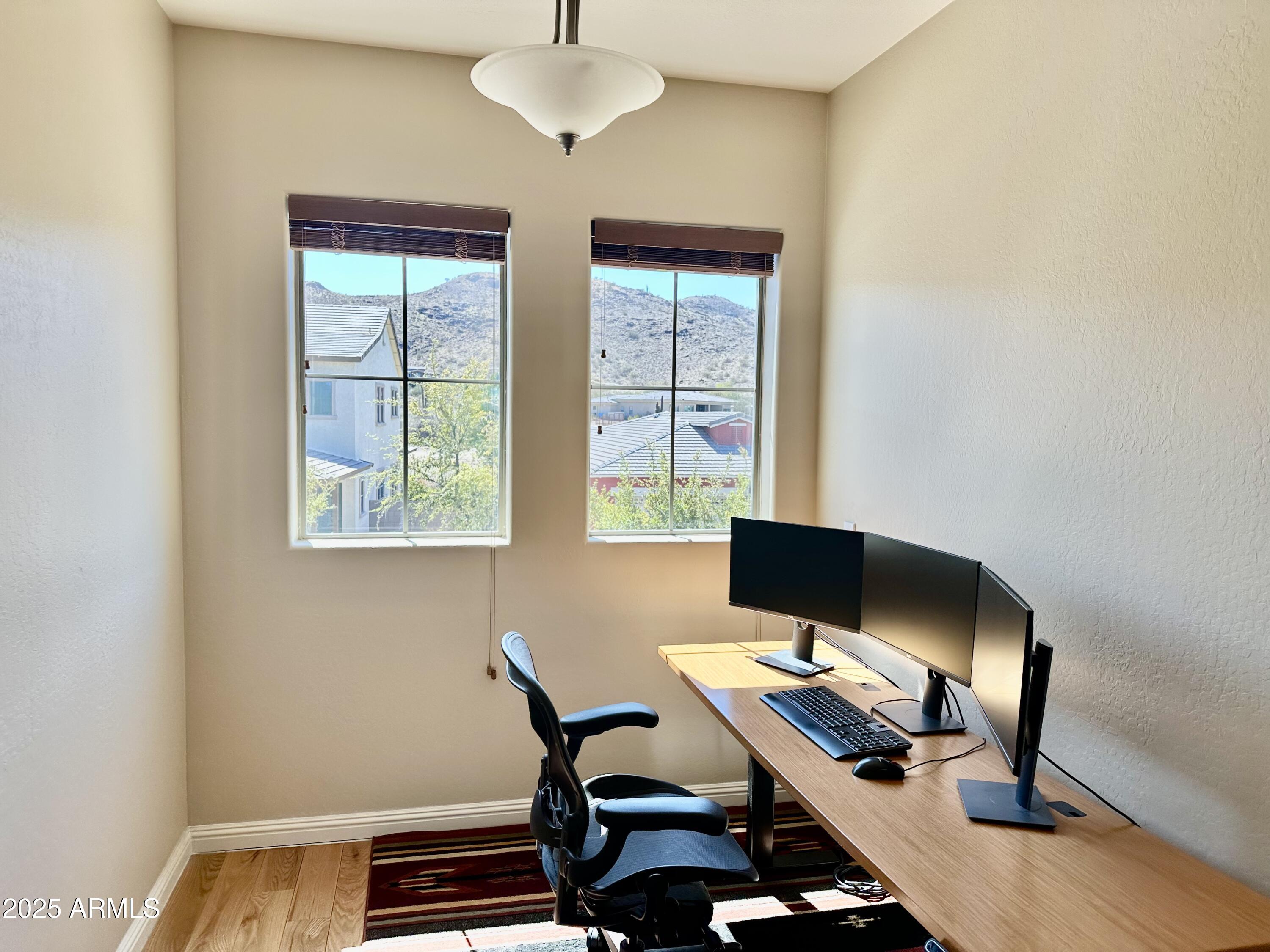 3914 East Constance Way Phoenix, AZ 85042 - Photo 4 of 81 a view of a workspace with furniture and a window