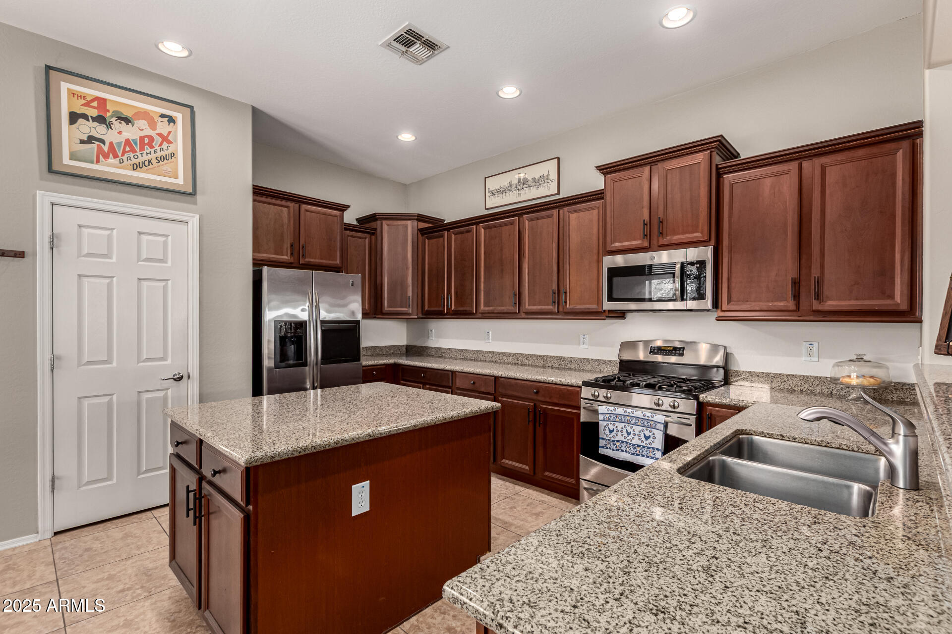 3914 East Constance Way Phoenix, AZ 85042 - Photo 9 of 81 a kitchen with stainless steel appliances granite countertop a sink stove microwave and refrigerator