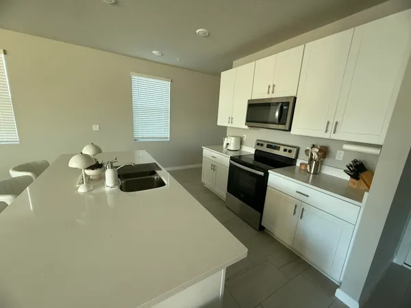 a kitchen with a sink a stove and cabinets