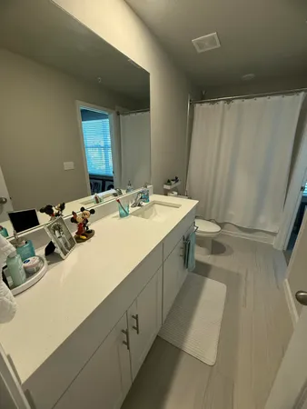 a en suite bathroom with a sink a mirror and a toilet