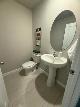 a bathroom with a sink toilet and a mirror