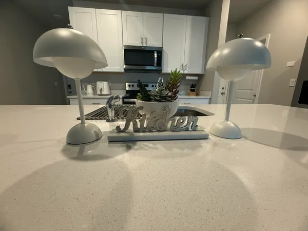 a kitchen with a sink a microwave and cabinets