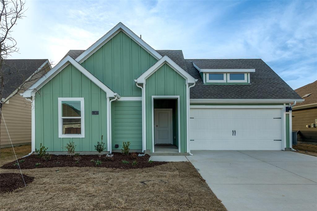 11357 Penz Street Providence Village, TX 76227 - Photo 3 of 22 View of front of house featuring a shingled roof, board and batten siding, and driveway