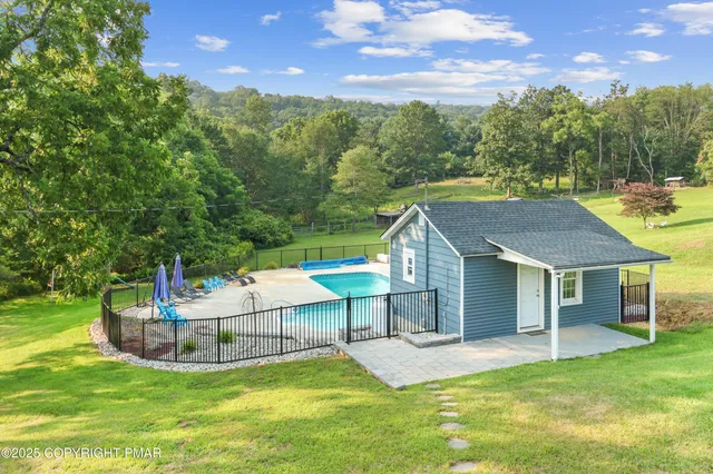 a view of a house with a yard and sitting area