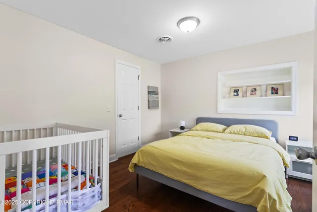 a bathroom with a granite countertop sink a mirror and a toilet